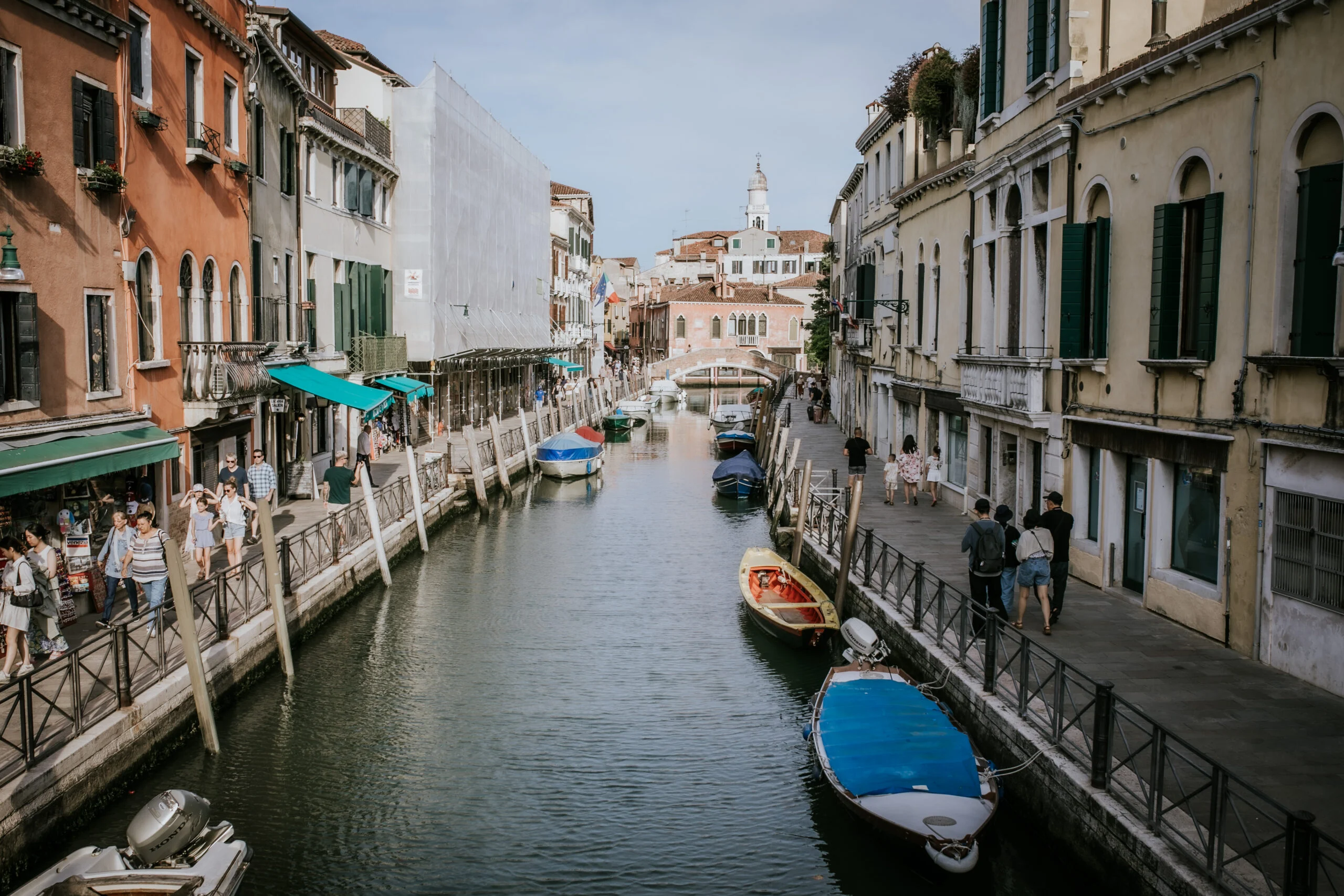 A quiet Venetian canal lined with moored boats