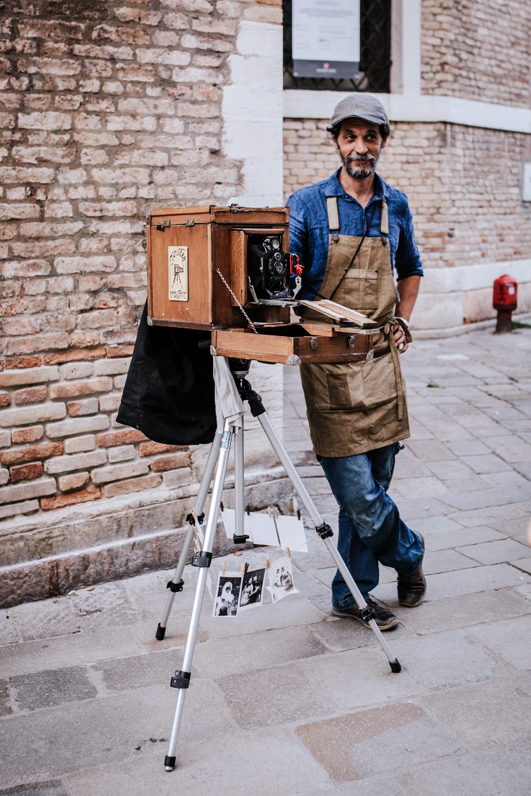 A street photographer with a large wooden plate camera in Venice