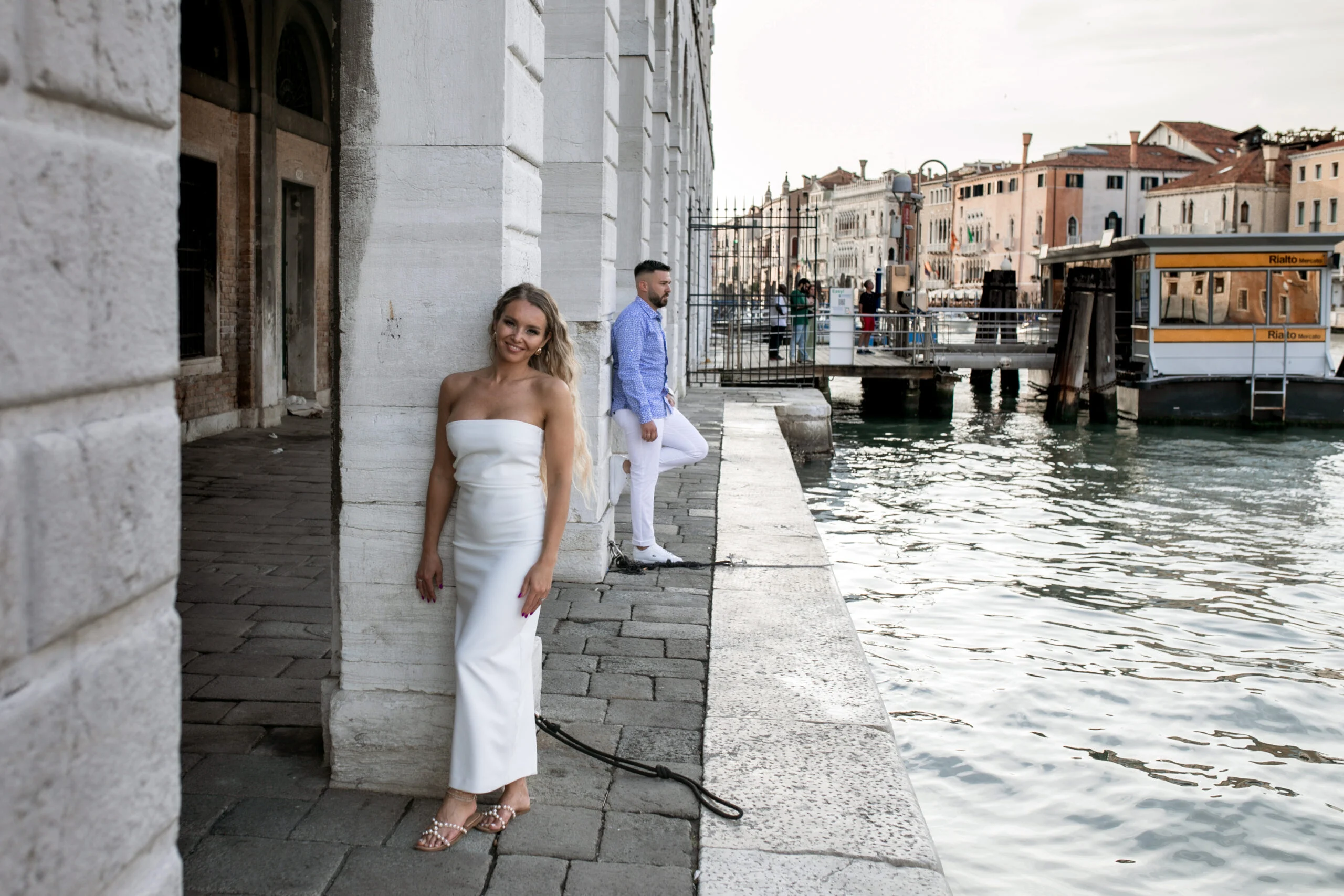 Couple on the stone quay beside the canal