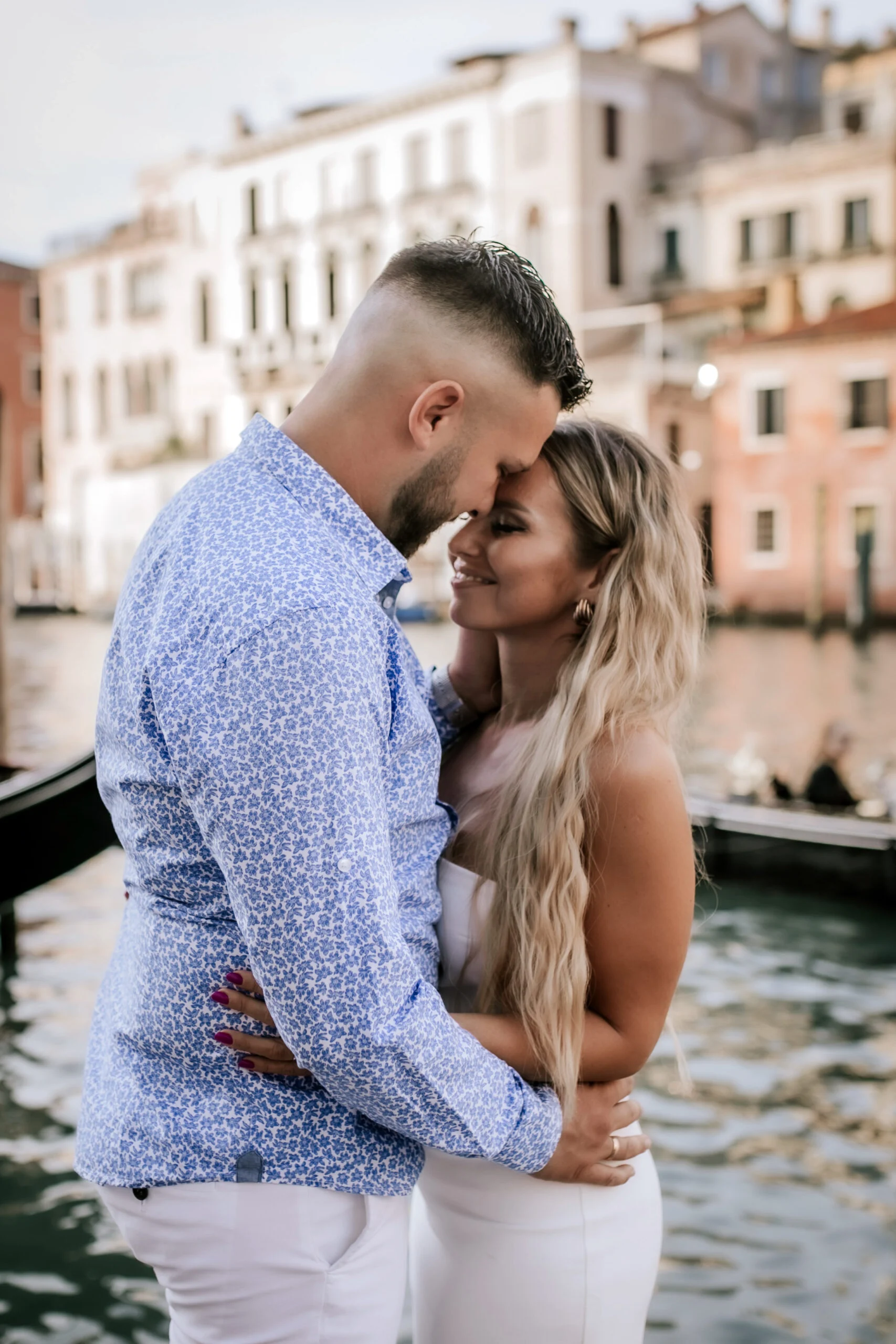 Couple close together on the bank of the Grand Canal