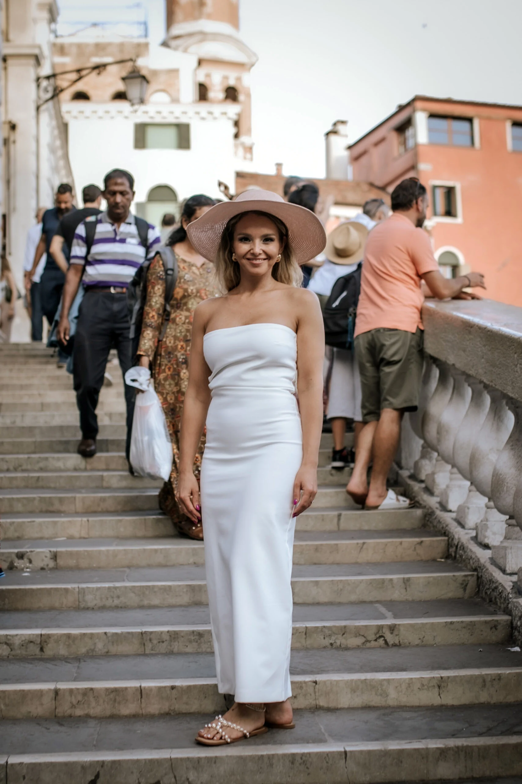 Woman walking down the steps of a Venetian bridge