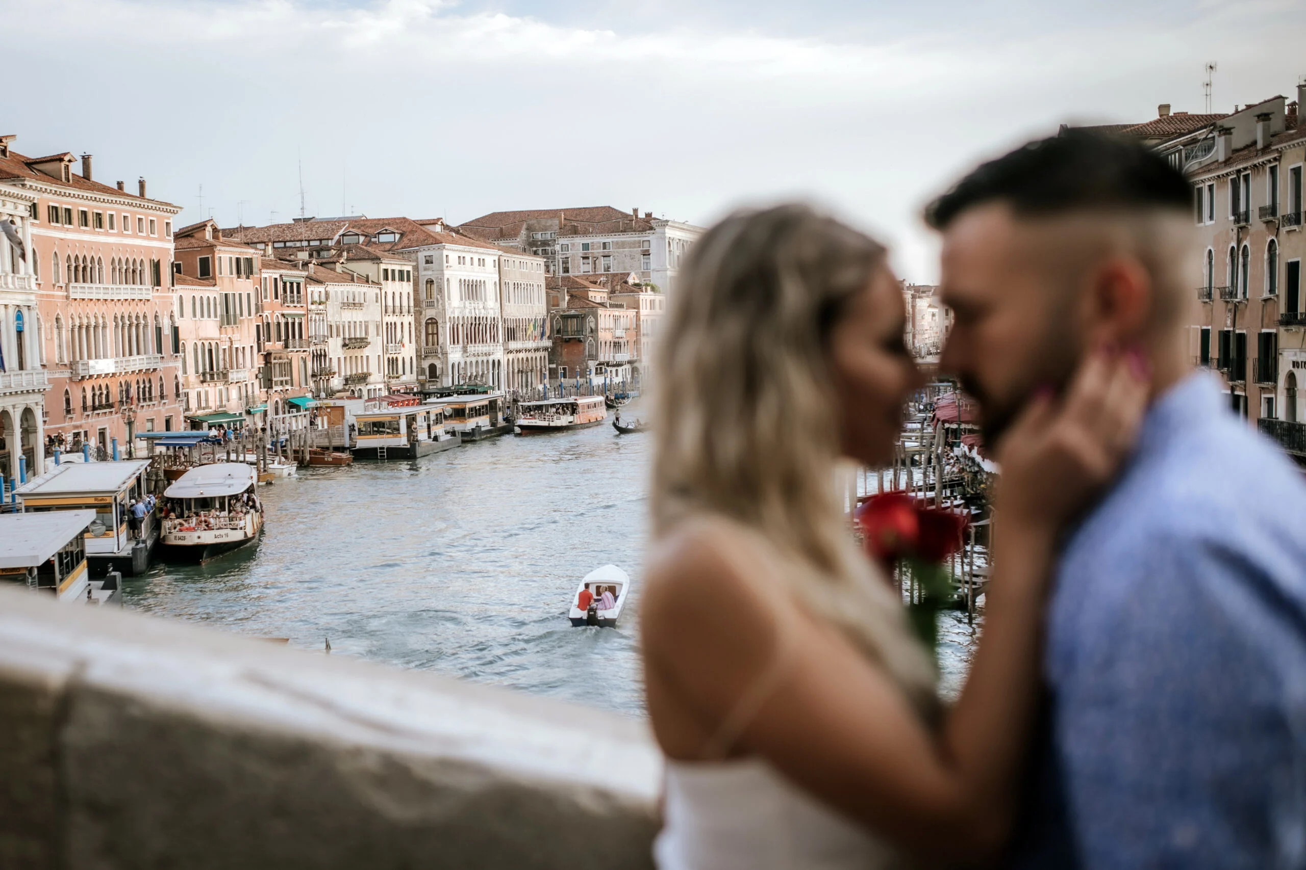 Couple embracing on the waterfront with the Grand Canal behind them