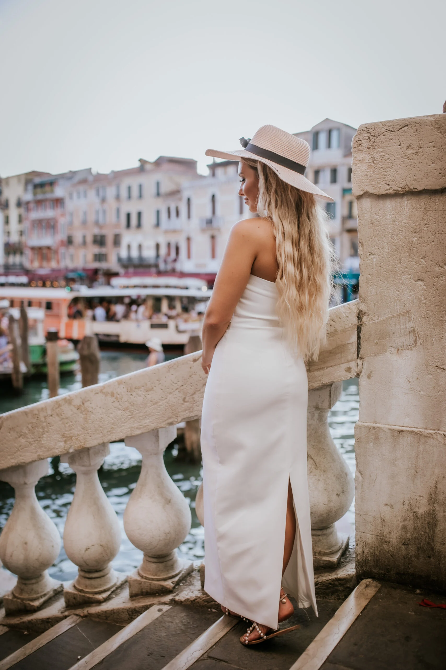 Woman standing on a bridge above the Grand Canal