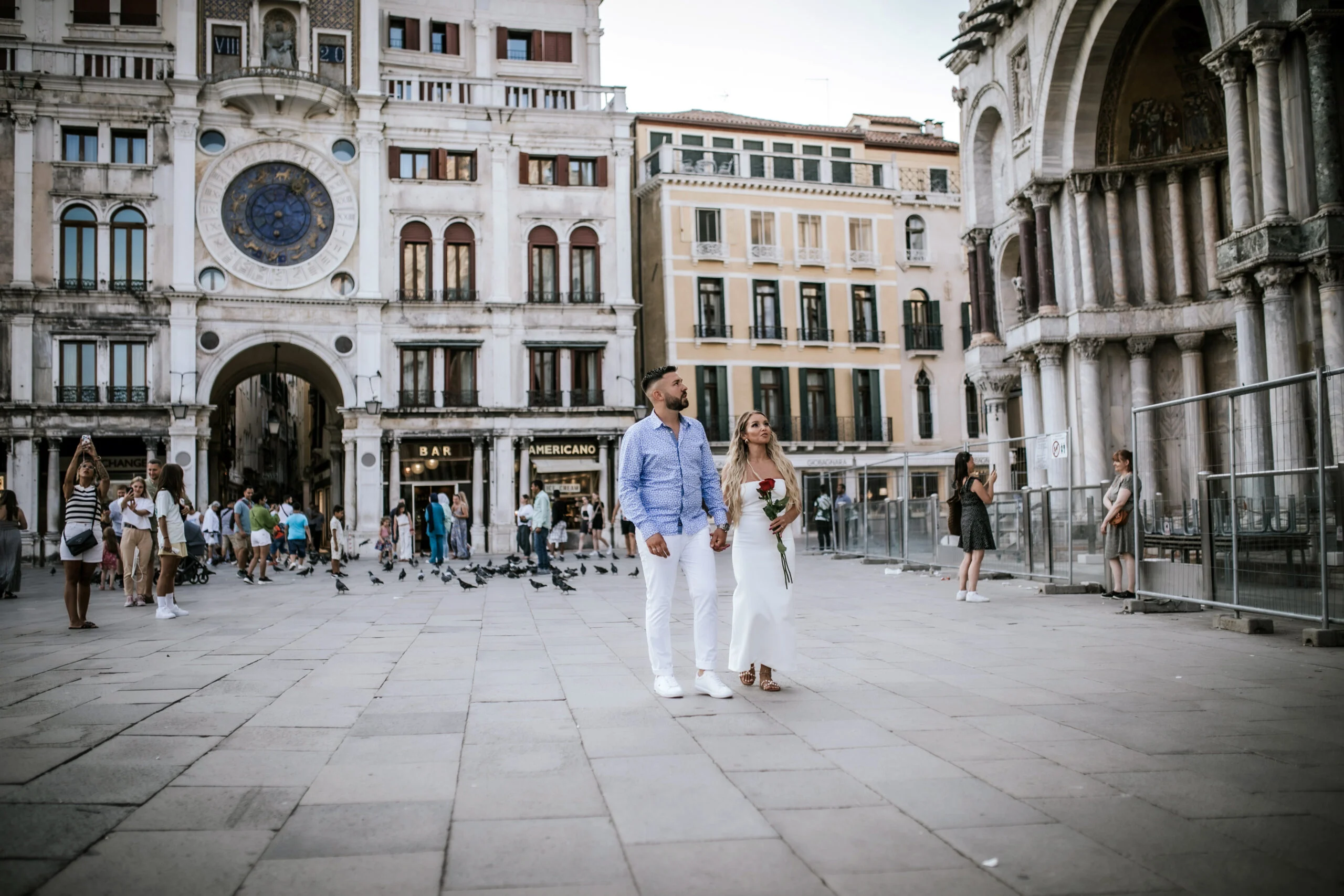 Couple walking away across the empty square