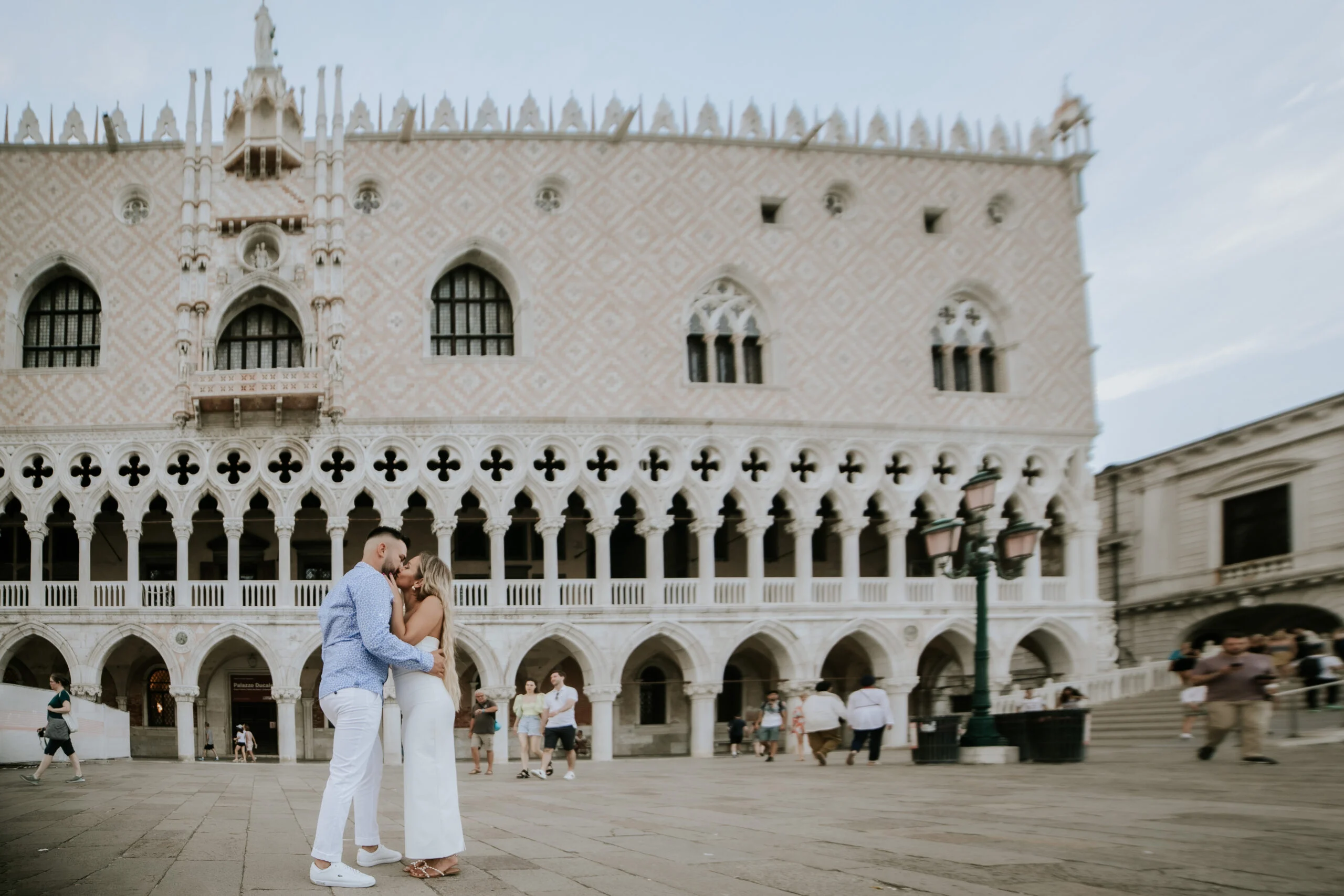 Couple standing on the waterfront beside the Doge's Palace