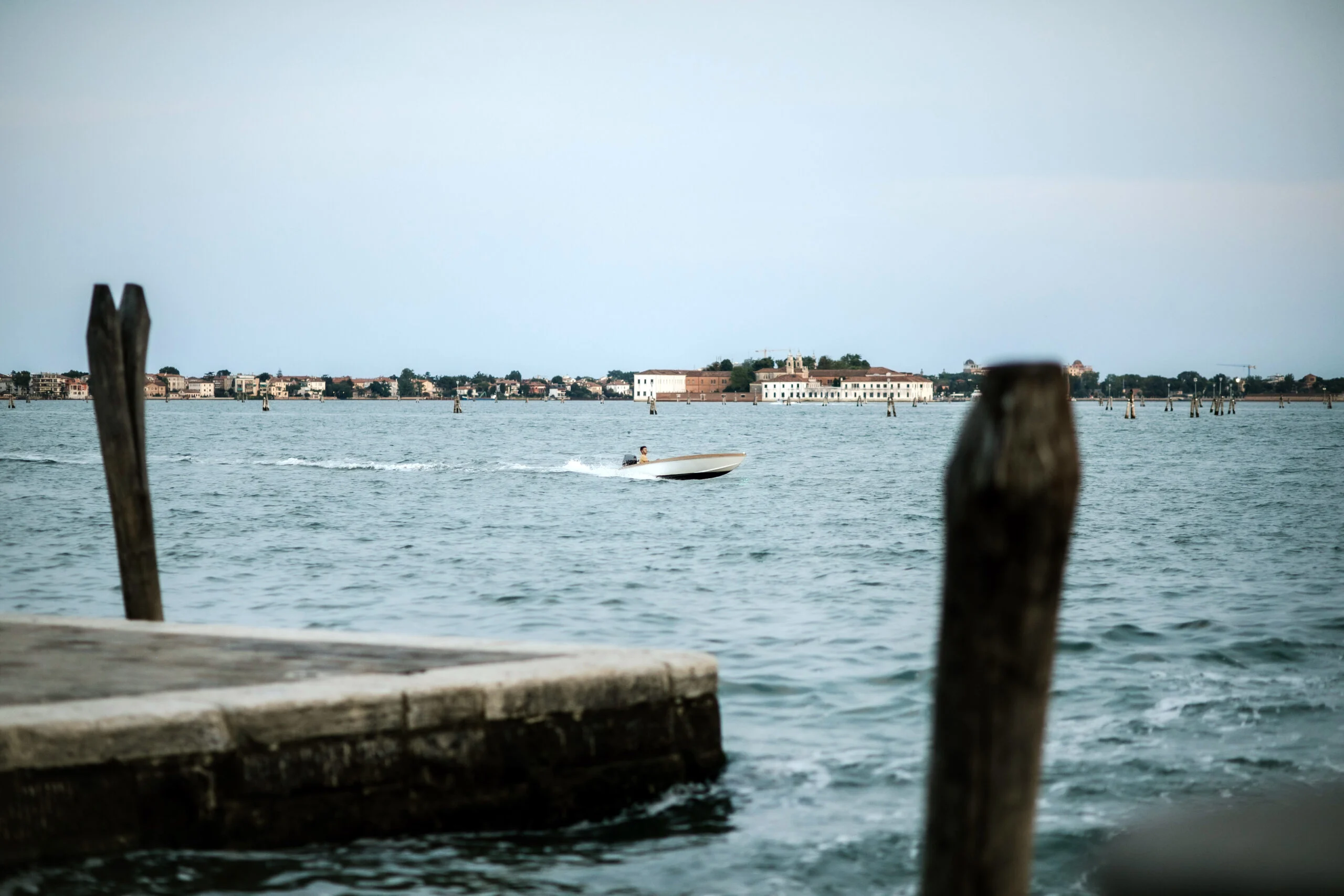 Wooden mooring poles standing in the Venetian lagoon
