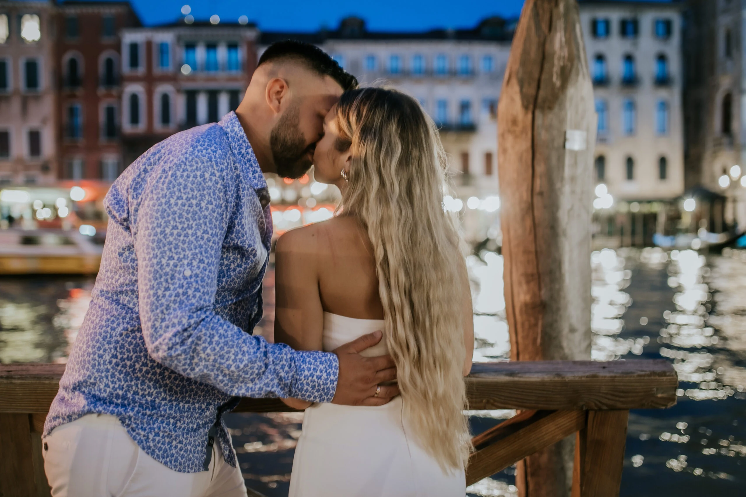 Couple embracing on the waterfront at dusk