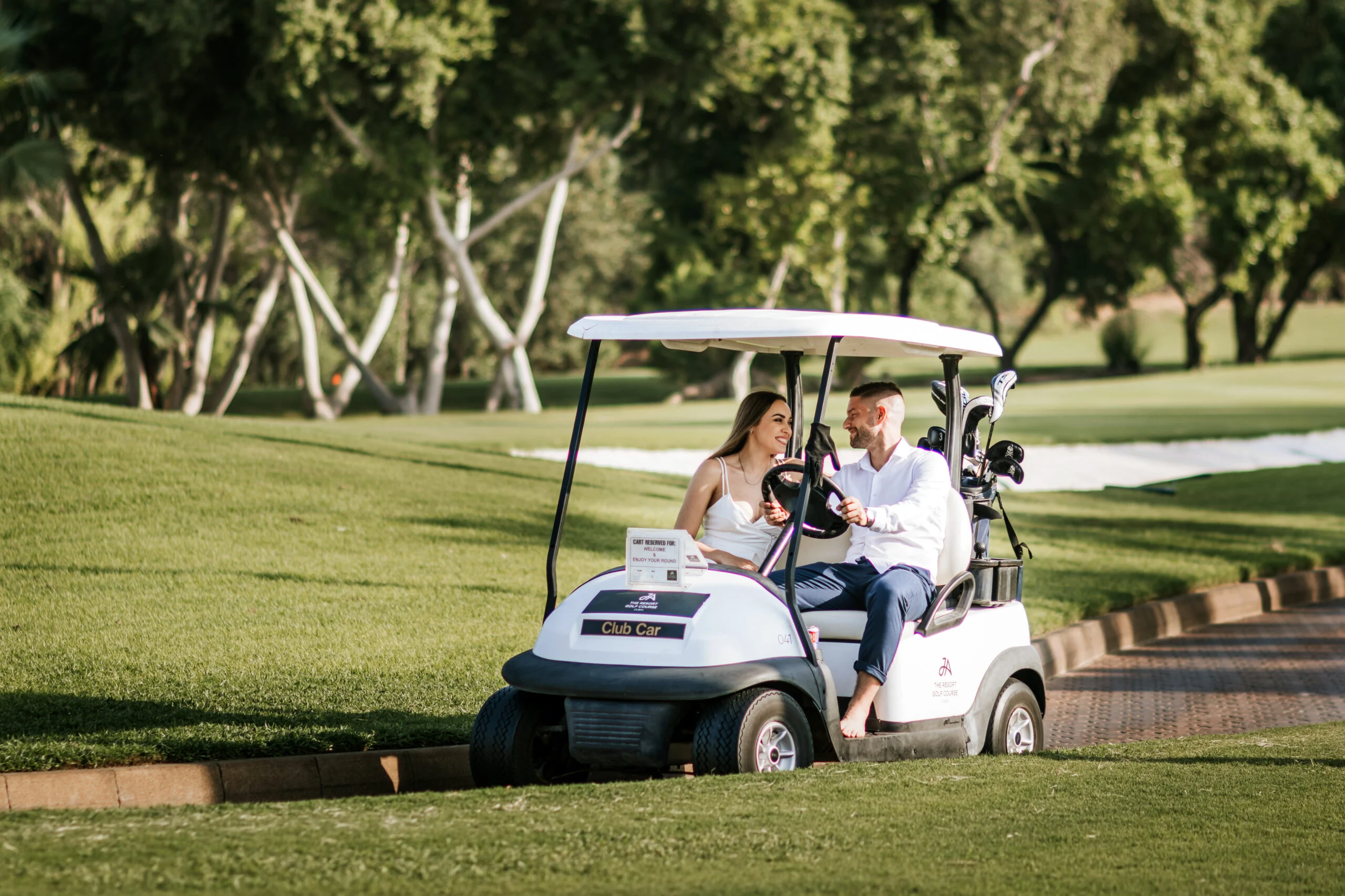 Woman driving a golf buggy along the fairway