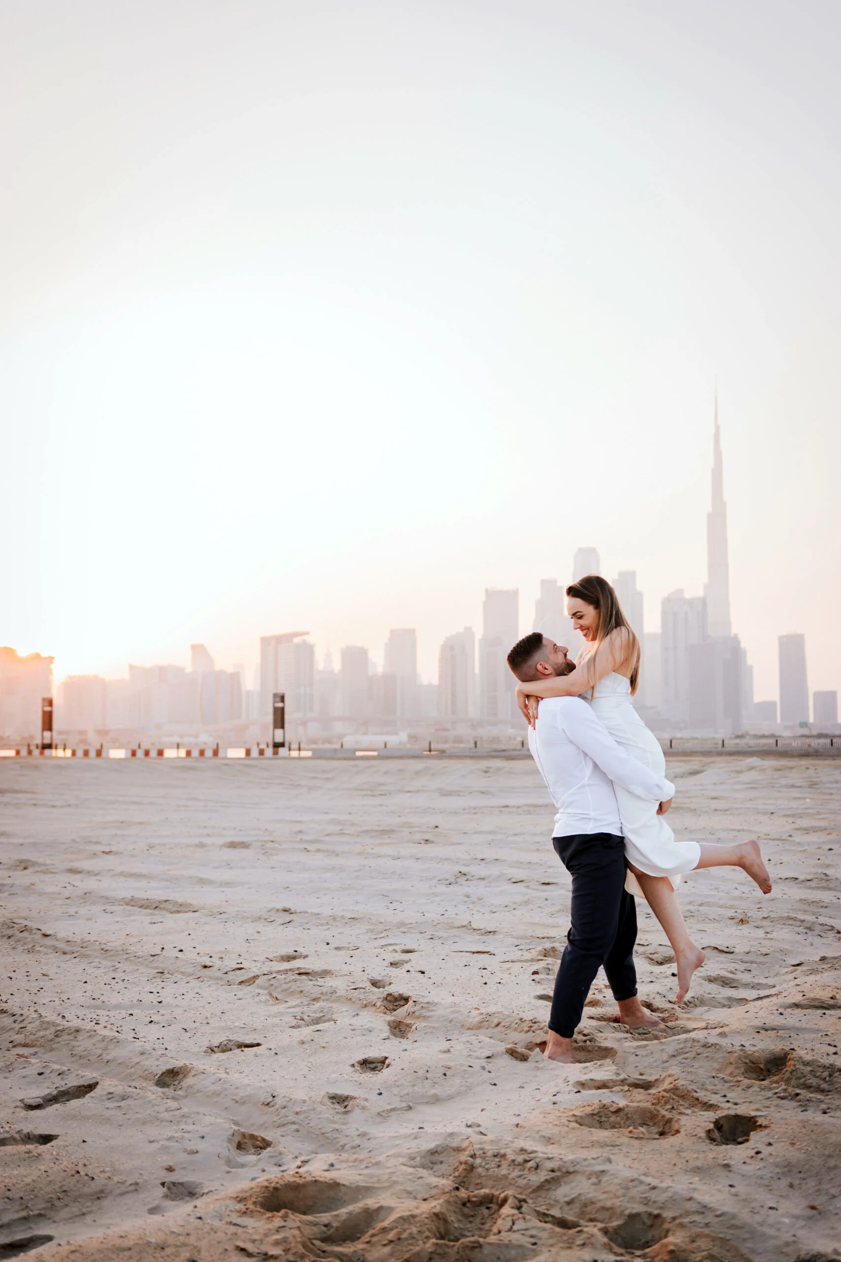 Couple dancing on the sand as the sun goes down