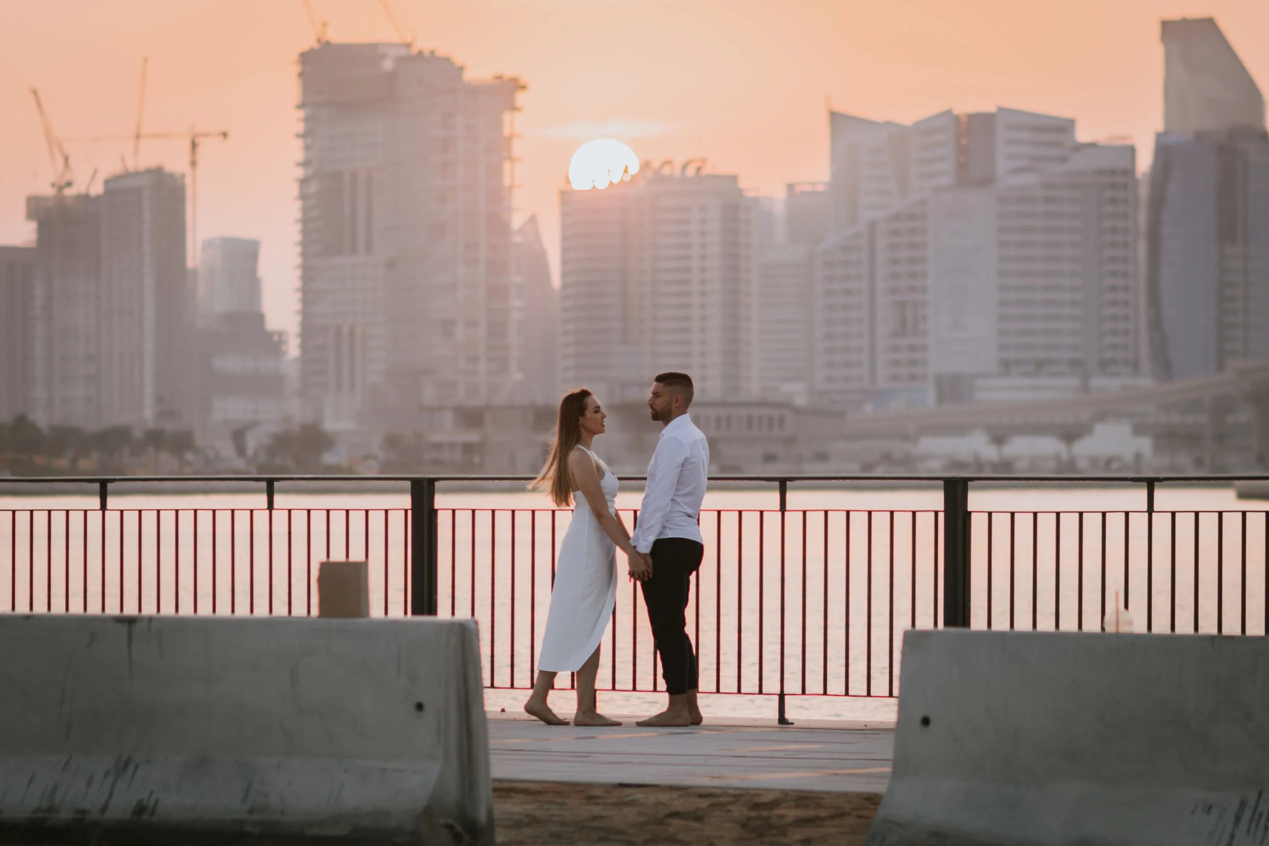 Couple embracing on the promenade above the marina