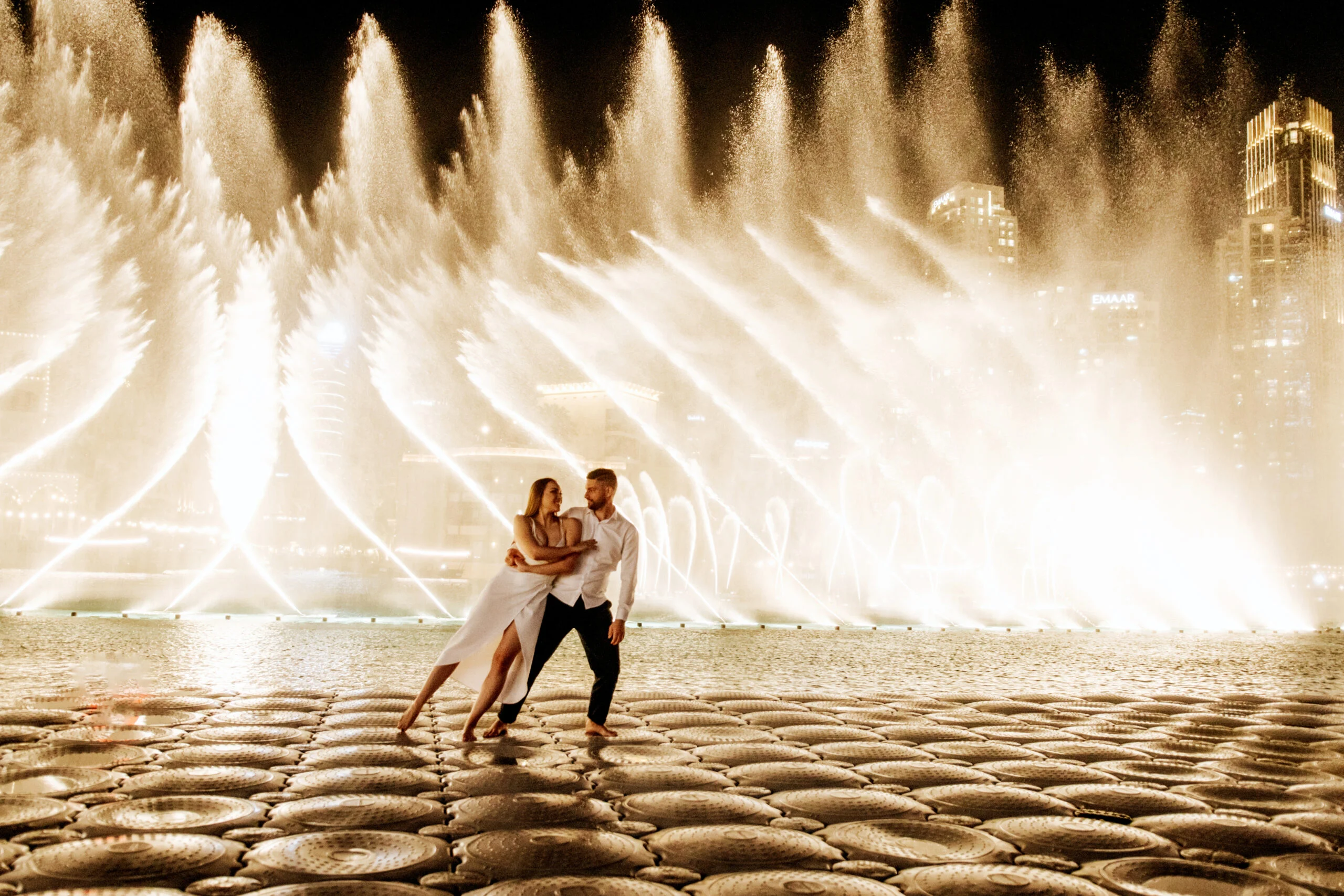 Couple embracing in front of the fountains