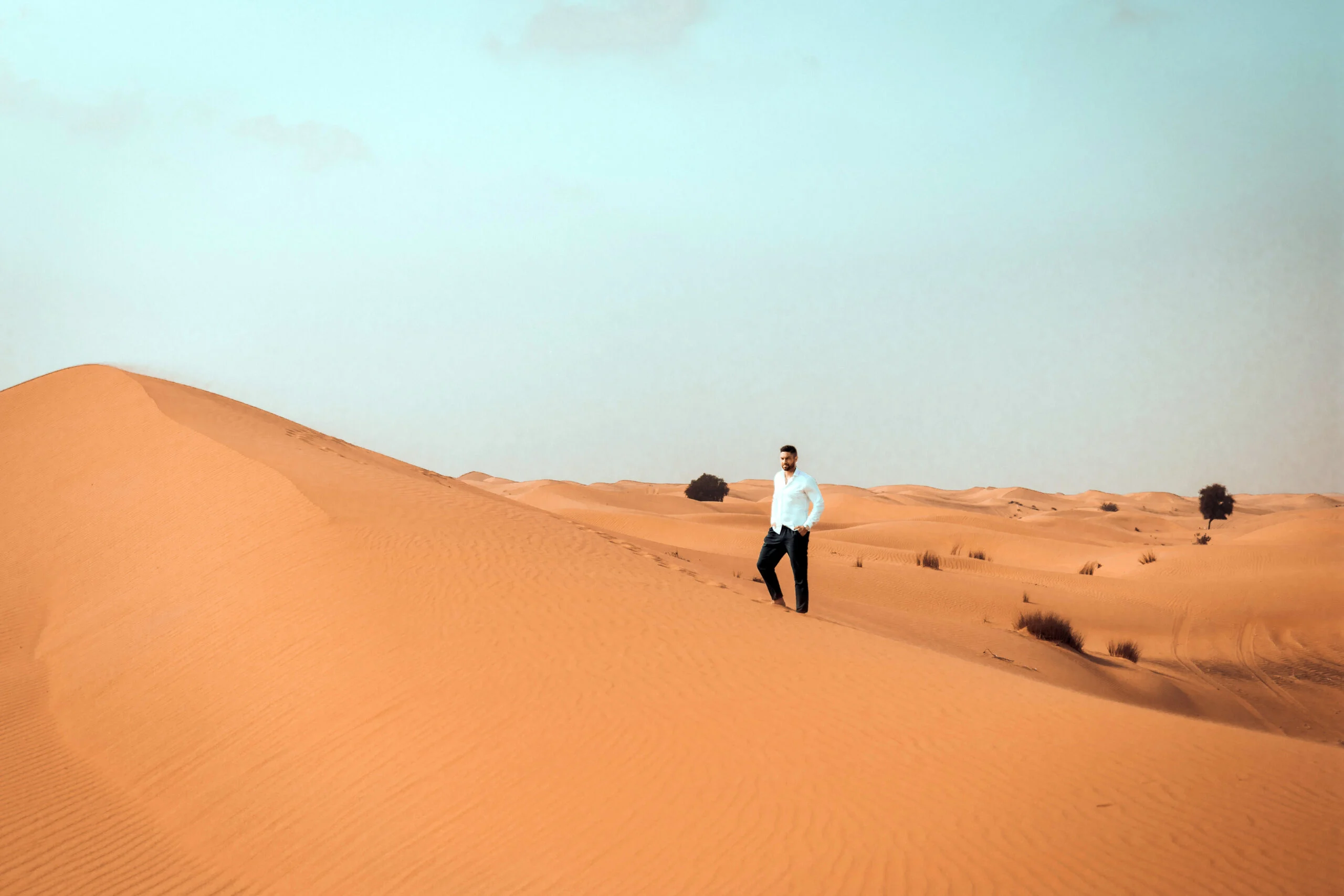 Man standing alone on a desert dune