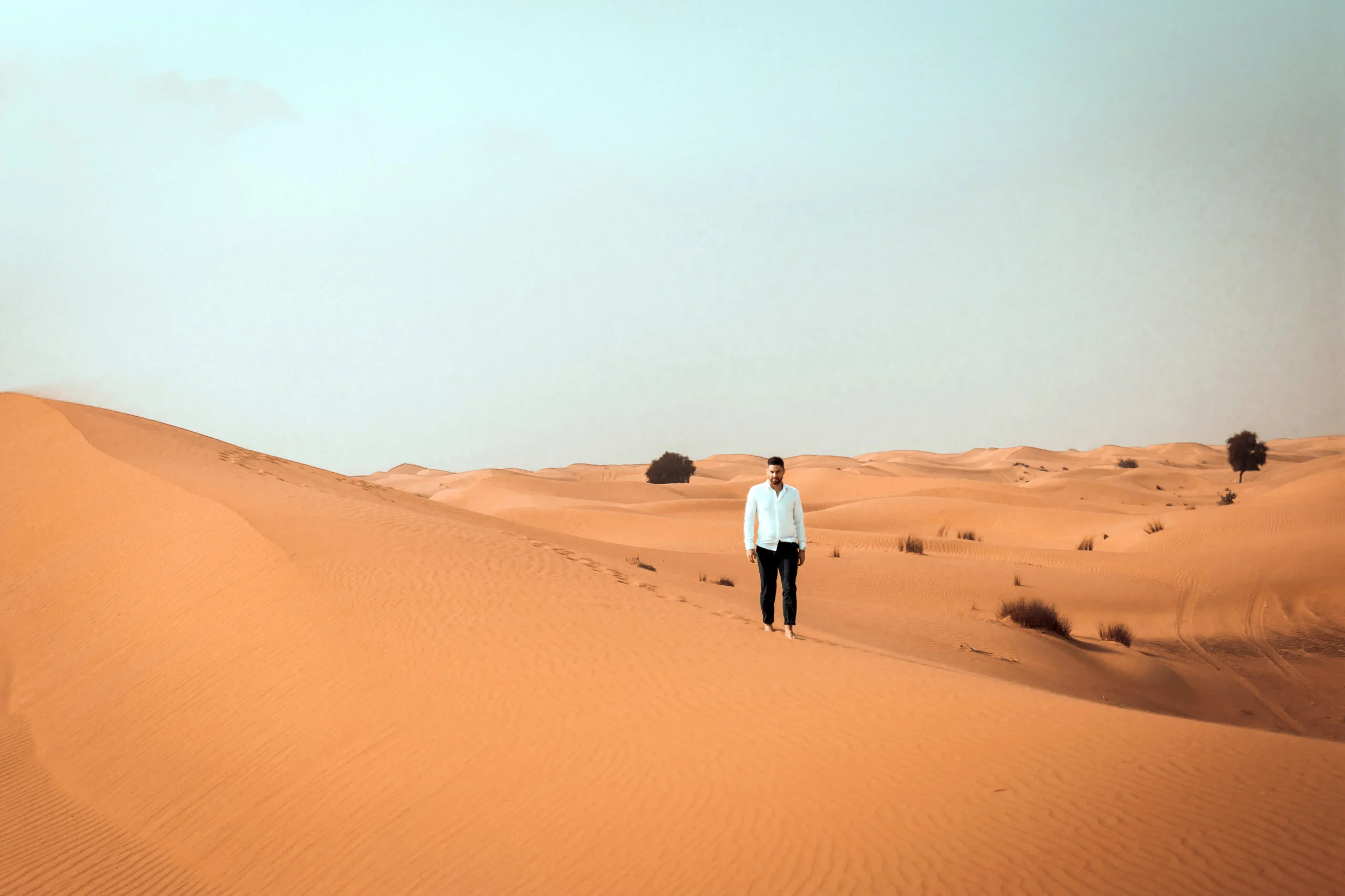 Man walking along the ridge of a dune