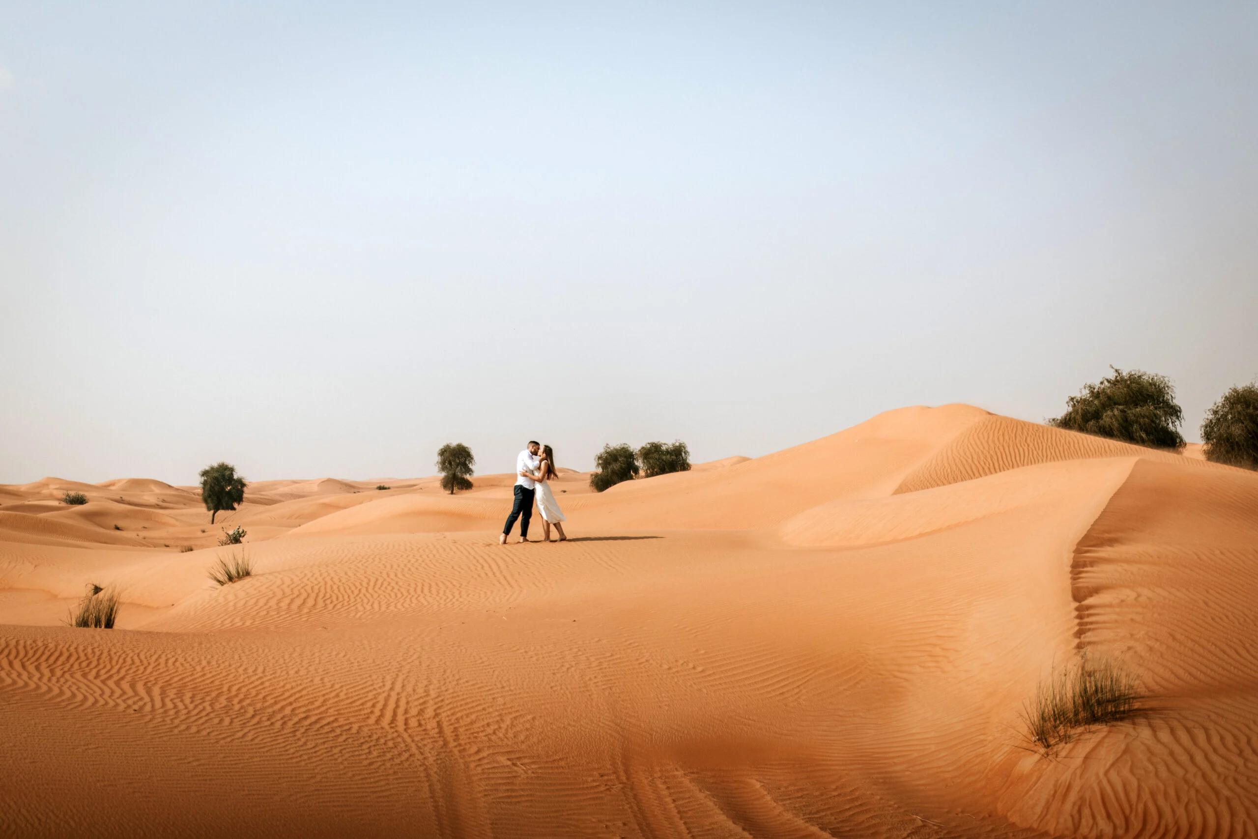 Couple embracing among the dunes