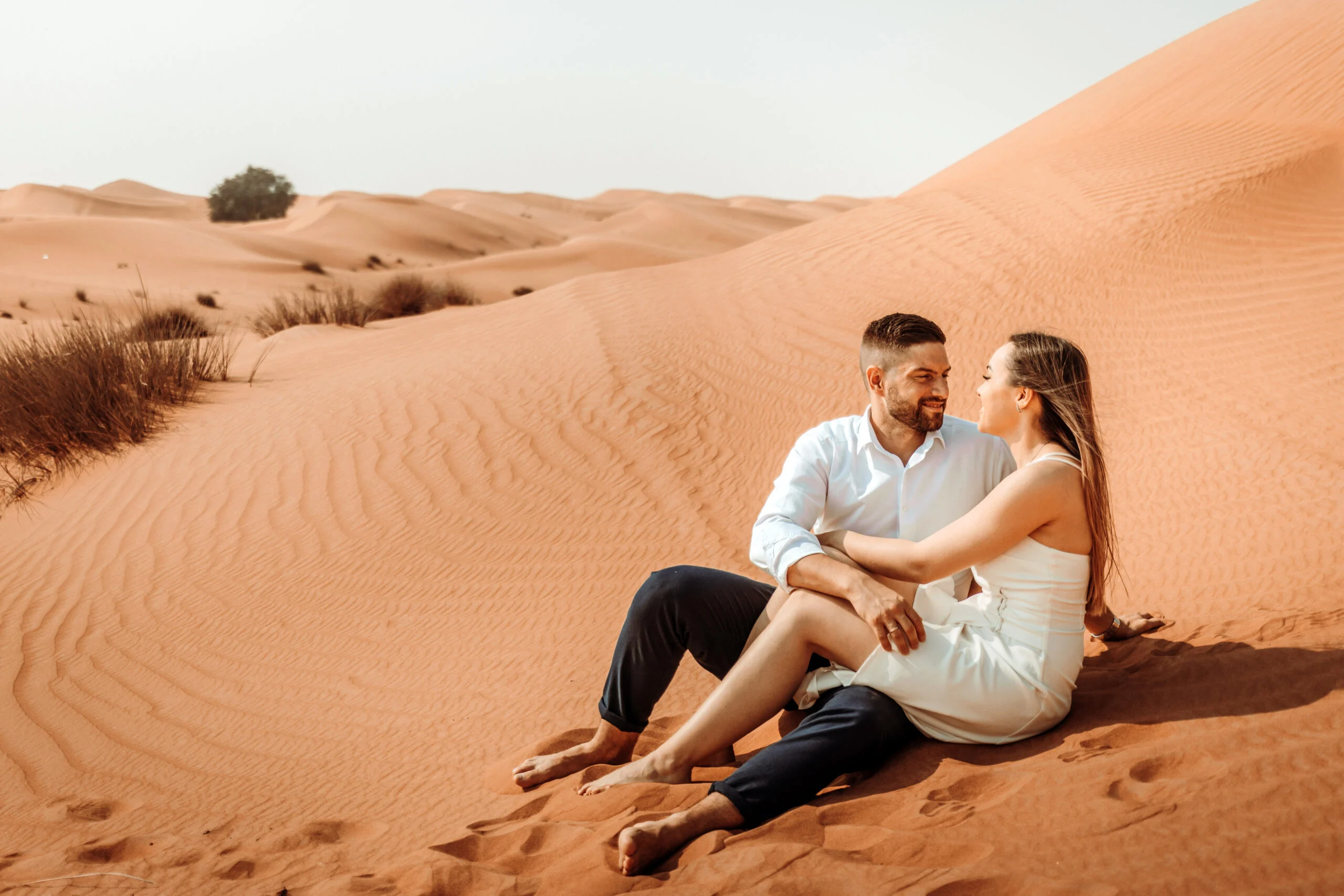 Couple sitting close together in the desert