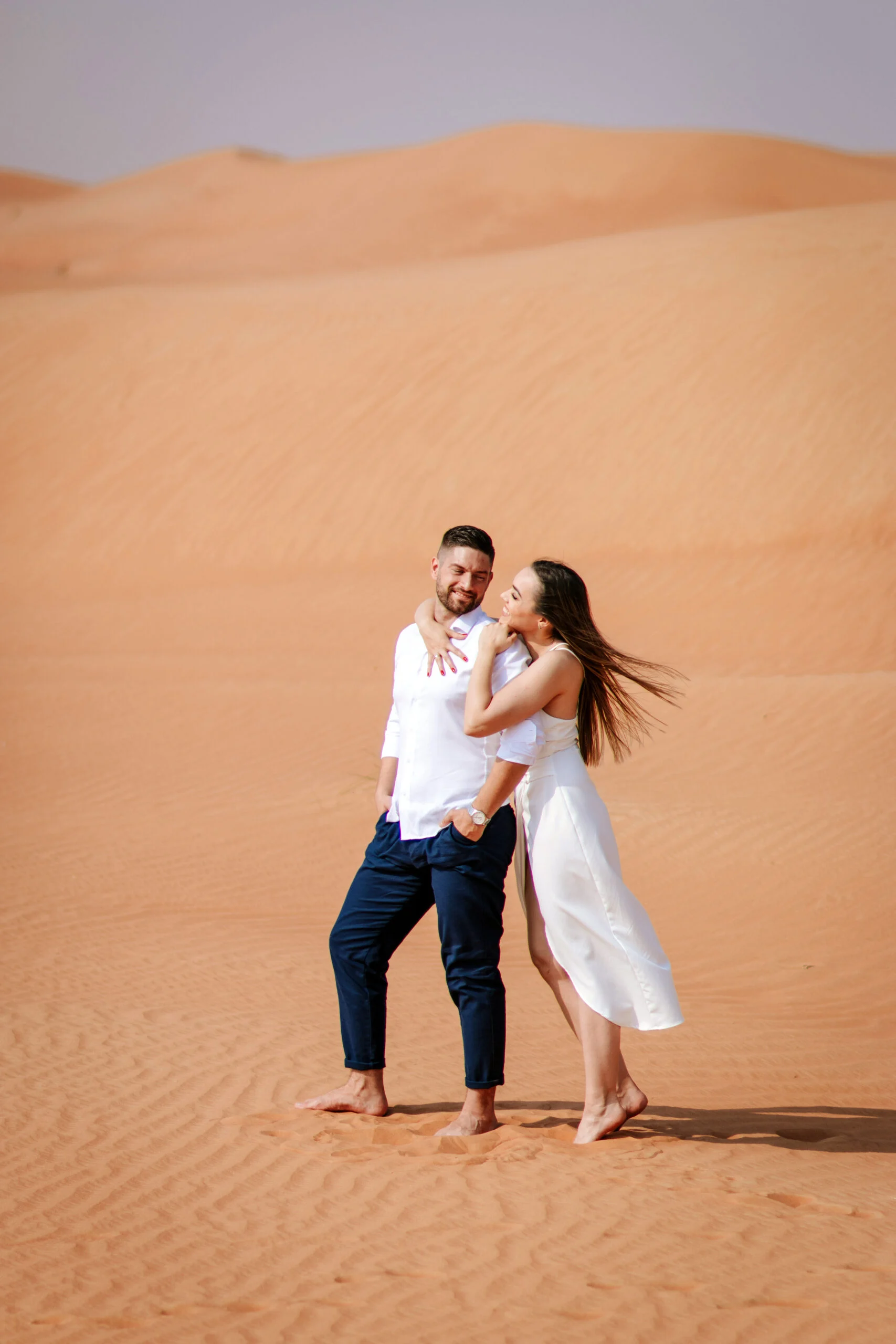 Couple standing together on the sand