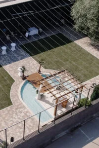 Garden wedding setting seen from above, with a pool and a wooden pergola