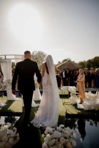 Bride and groom walking back down the aisle after the ceremony, guests standing on both sides