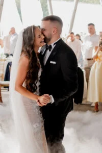 Bride and groom during the first dance, low smoke drifting across the floor
