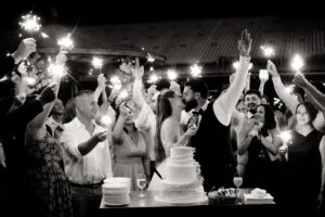 Black and white photograph of the cake surrounded by raised sparklers