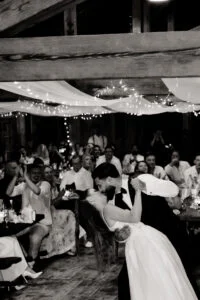 Black and white photograph of the bride greeting guests at the dinner
