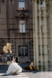 Couple reflected in glass, with a historic Belgrade facade layered over them