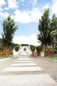Gravel path leading to the ceremony gateway, chairs set out on either side