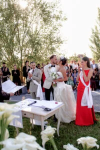 Bride and groom signing the register at an outdoor ceremony