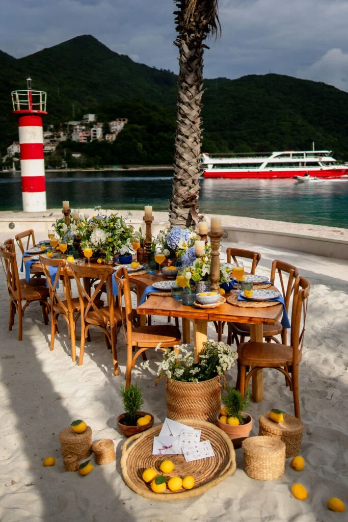 The wedding table seen along its length, with a lighthouse across the water