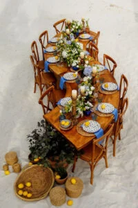Aerial view of the wedding table set with flowers, lemons and blue ceramics