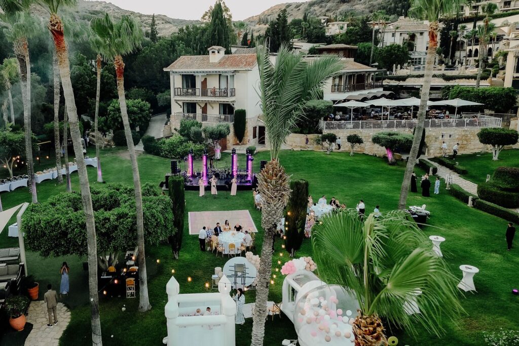 Aerial view of the lit gardens and terraces of a resort in Cyprus at dusk