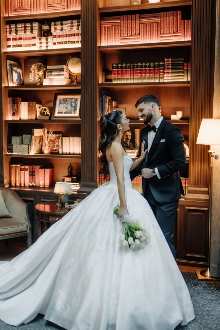 Bride and groom among the bookshelves at Hotel Bristol