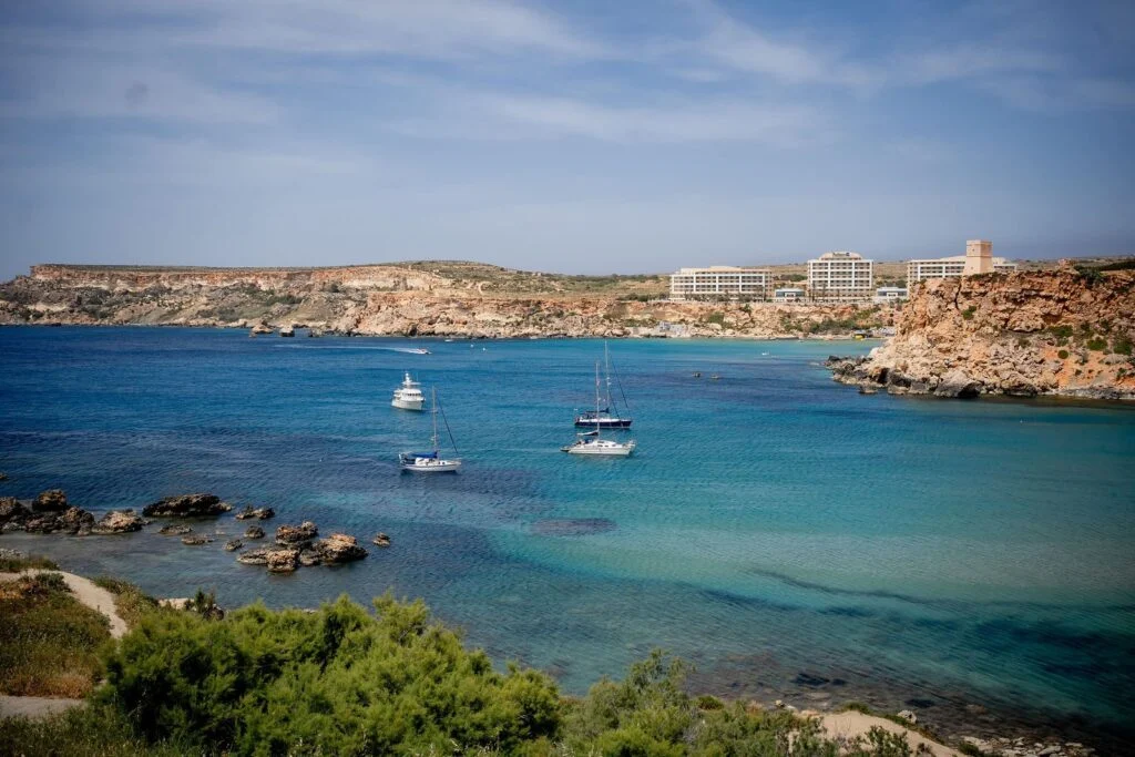 Boats anchored in a turquoise bay in Malta