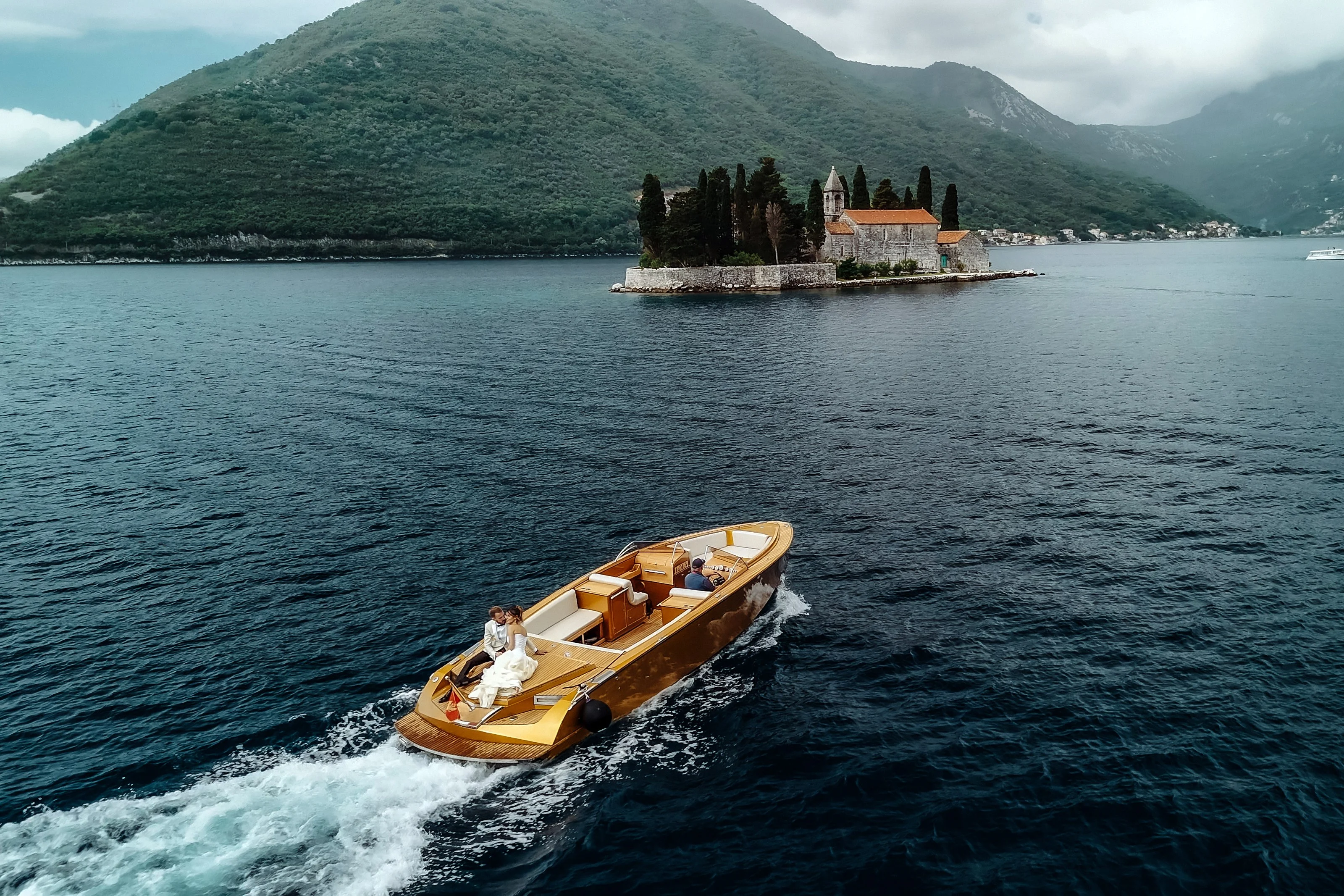 Wooden boat on the bay with an island church behind it