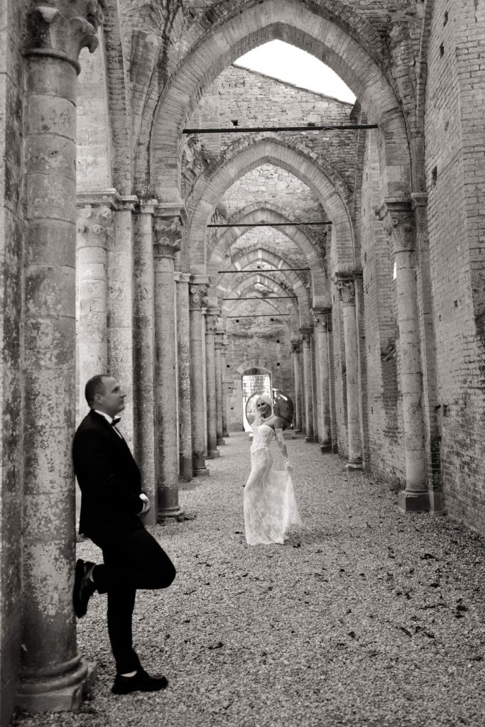 Black and white photograph of the couple in the colonnaded nave of the abbey
