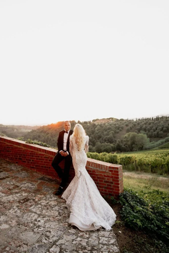Bride and groom at the terrace wall in the evening light