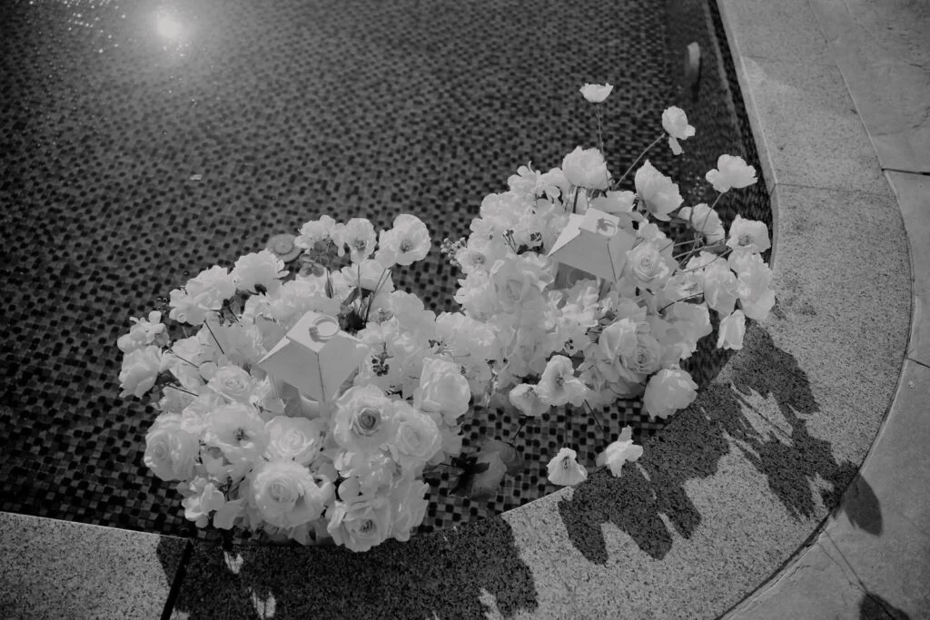 White roses arranged on a dark polished floor