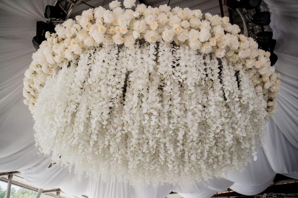 Large hanging installation of white flowers above the dance floor