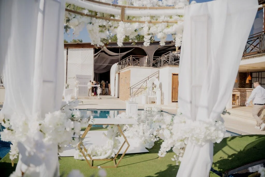 White drapes and the pool at the estate before the ceremony