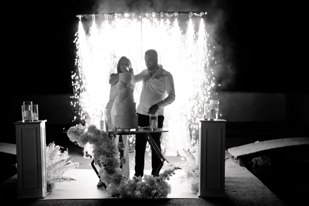 Black and white photograph of the couple behind a curtain of sparks