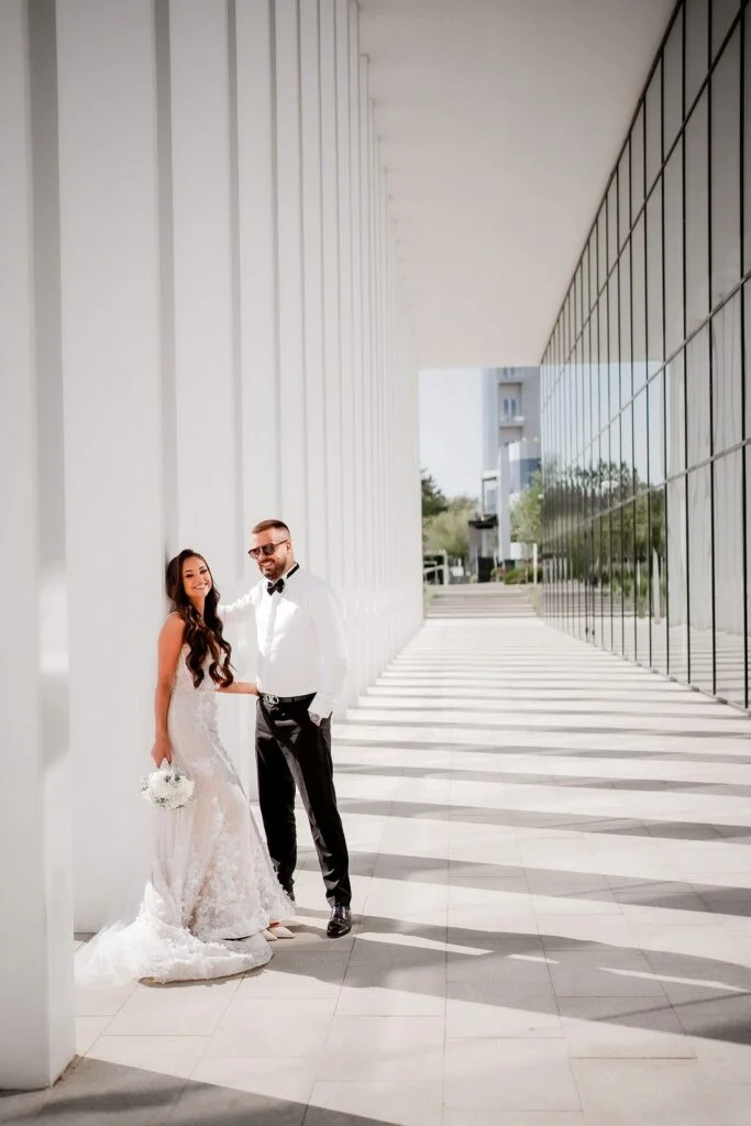 Bride and groom in the shade of the white columns